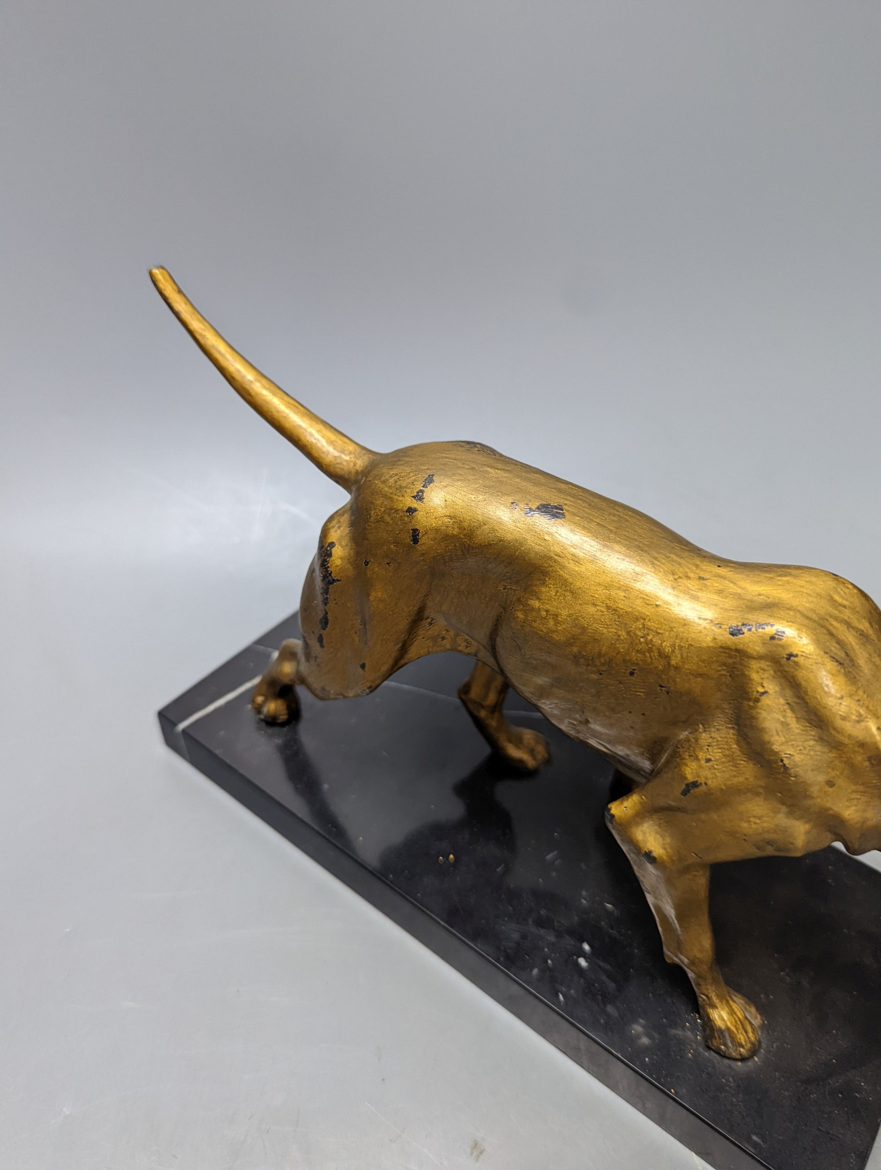 A gilt-metal model of a pointer on marble base 29cm